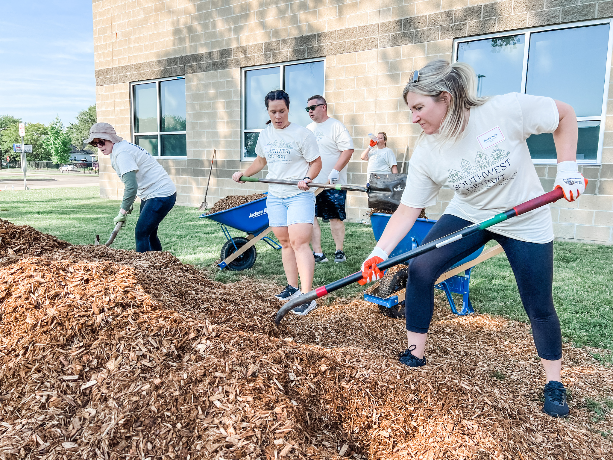 people volunteering together to do landscaping