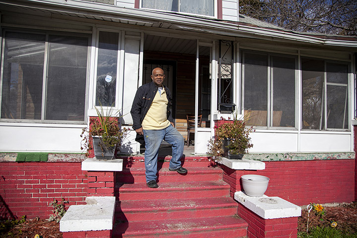 Rev. Larry in front of his home