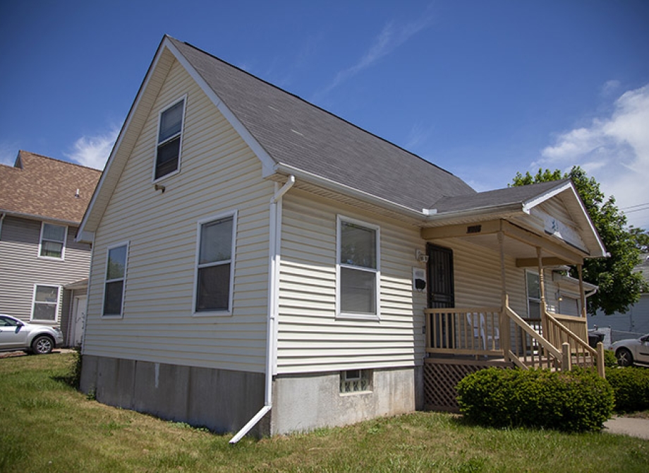 Corner view of a house with a front porch