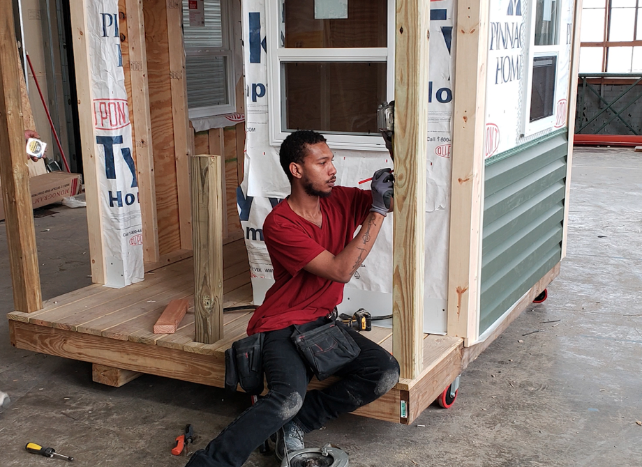Two men building a wall for a house