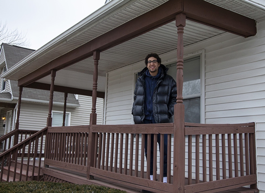 Andrey in front of his new home
