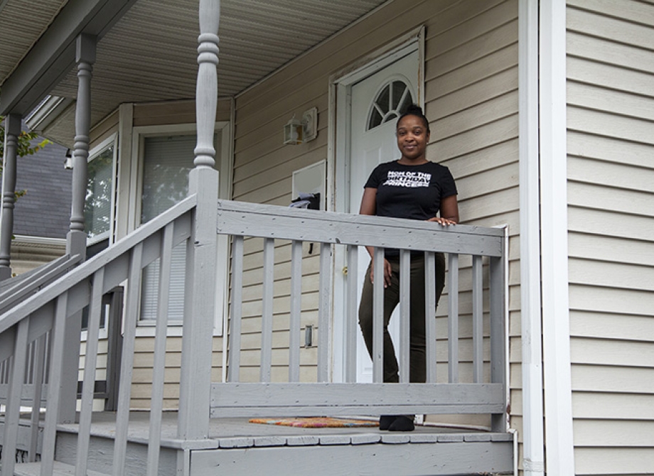 Lachelle in front of her new home.