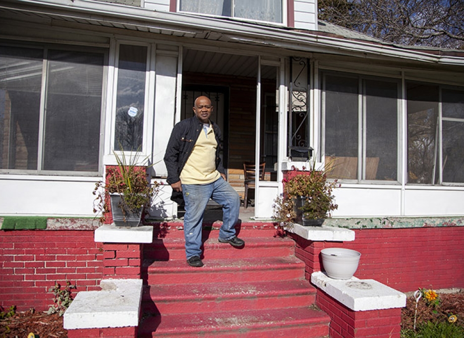 Rev. Larry in front of his home