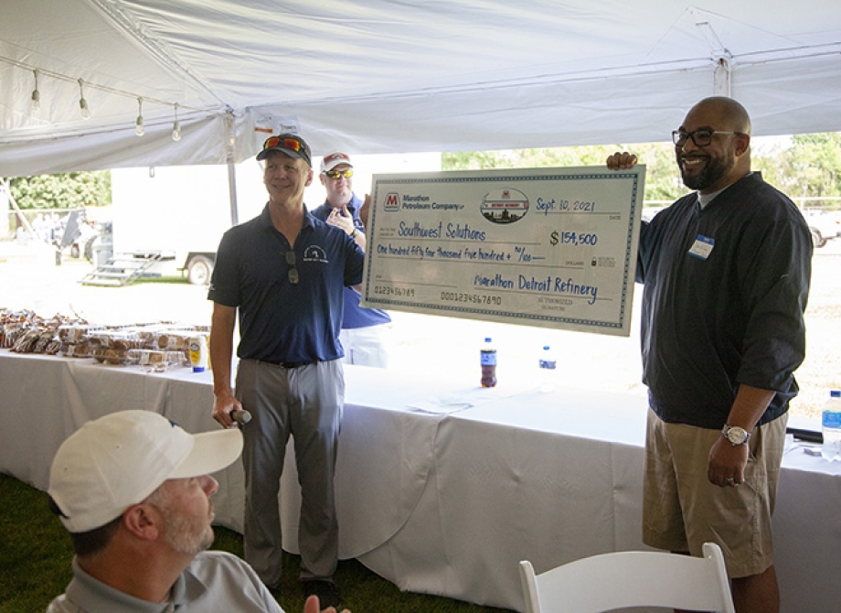 Marathon GM Dave Leaver presents a ceremonial check to Southwest Solutions President and CEO, Sean de Four