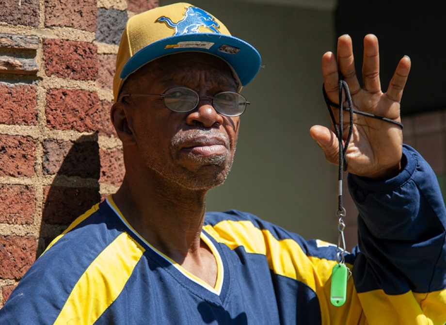 Willie Brown outside his apartment building with his keys in hand