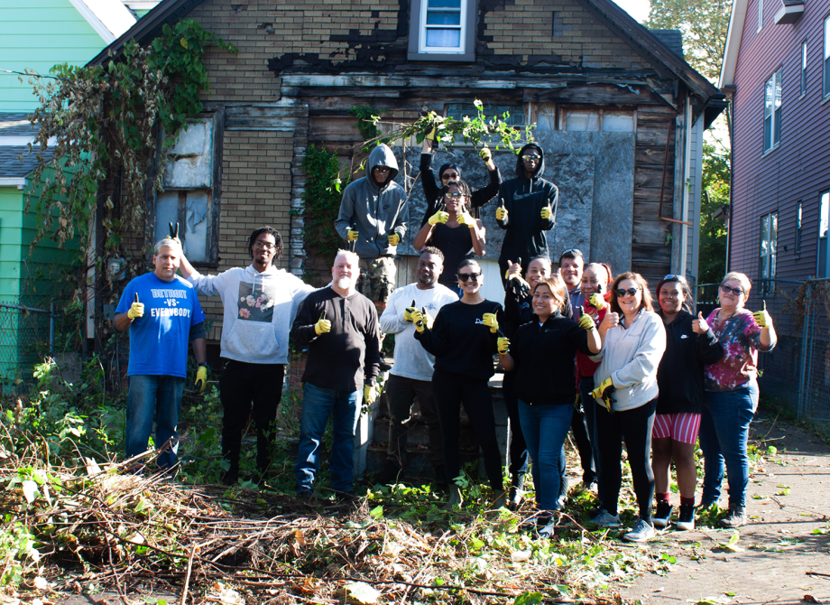 Group of youth and their leaders standing in front of a house in southwest Detroit