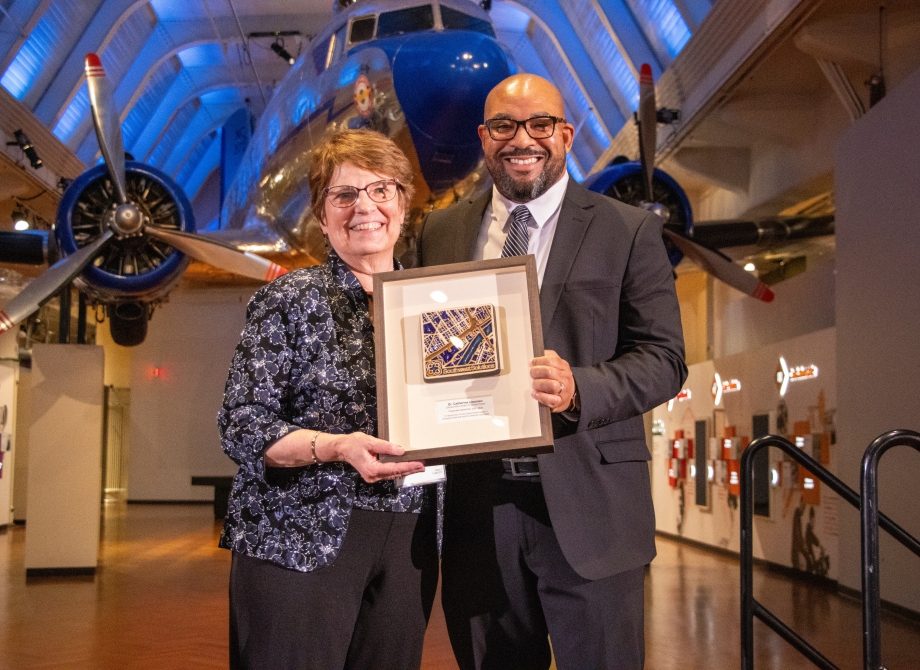 Cathy Liesman receives the Clement Kern Award for Social Impact from Sean  de Four, President and CEO of MiSide