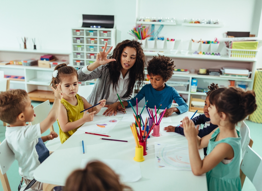 an art teacher helping her young students learn to draw