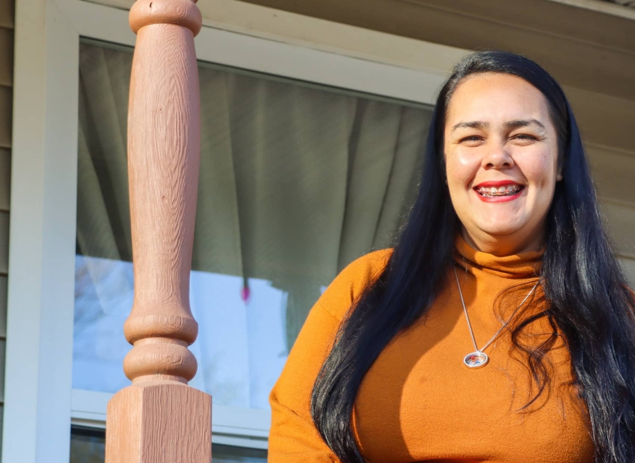 Woman Smiling in front of her home