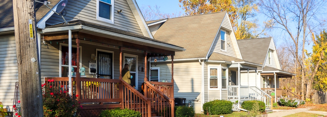 Three homes on a quiet neighborhood street on a sunny spring day