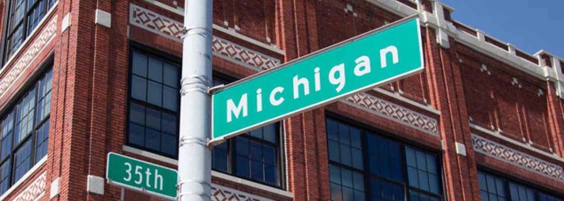 a street sign in front of a building says Michigan and 35th