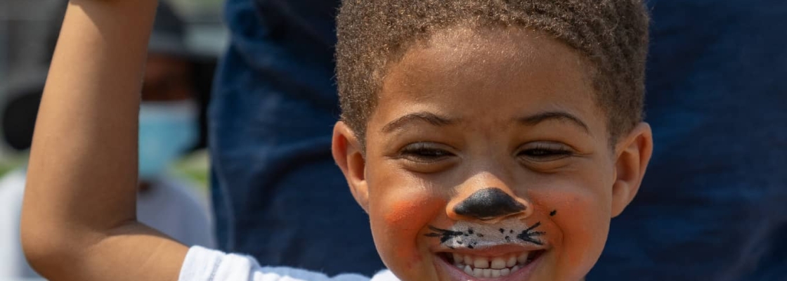Child with face painting smiling