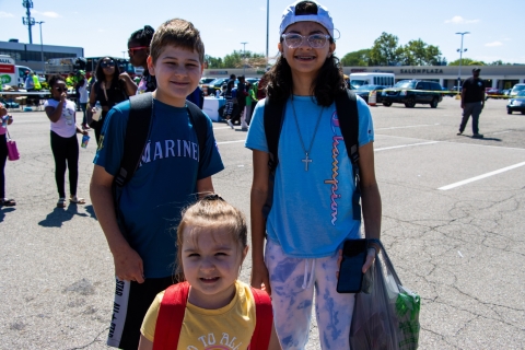 Three kids taking a photo