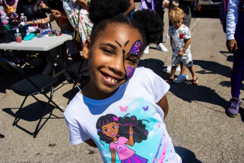 A girl with face painting smiling