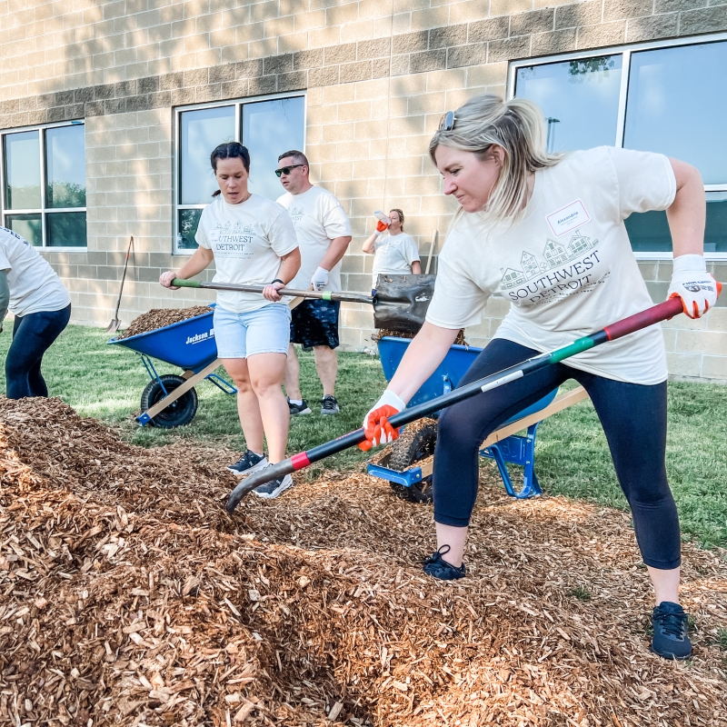 people volunteering together to do landscaping