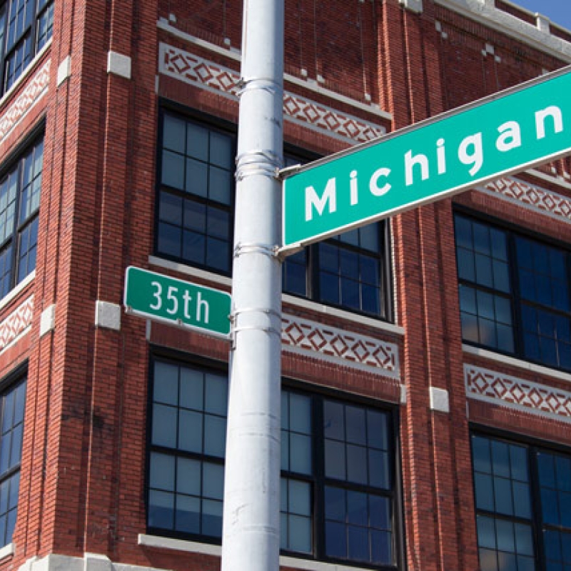 a street sign in front of a building says Michigan and 35th