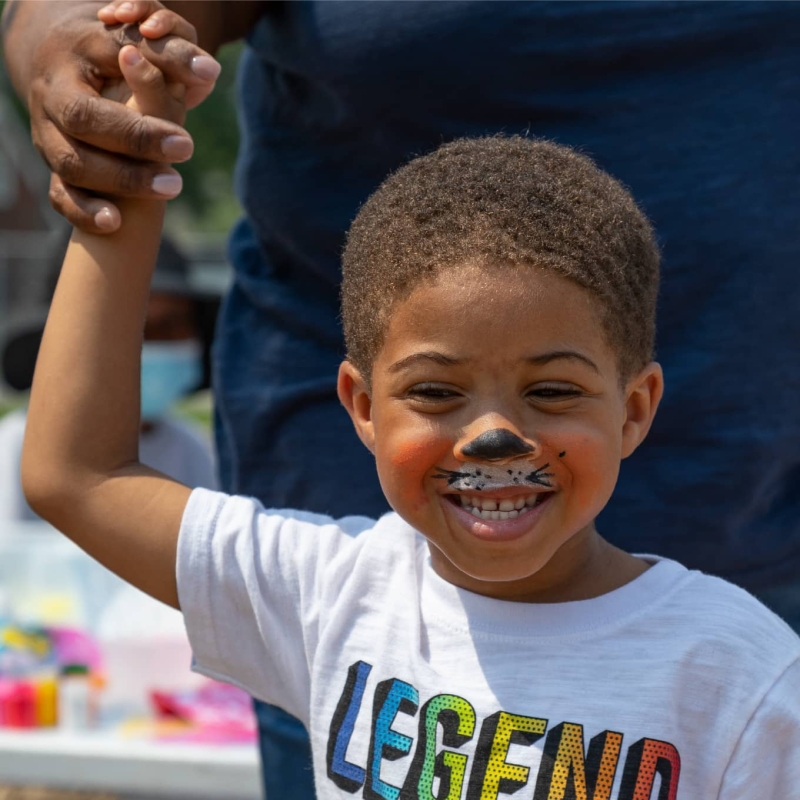 Child with face painting smiling