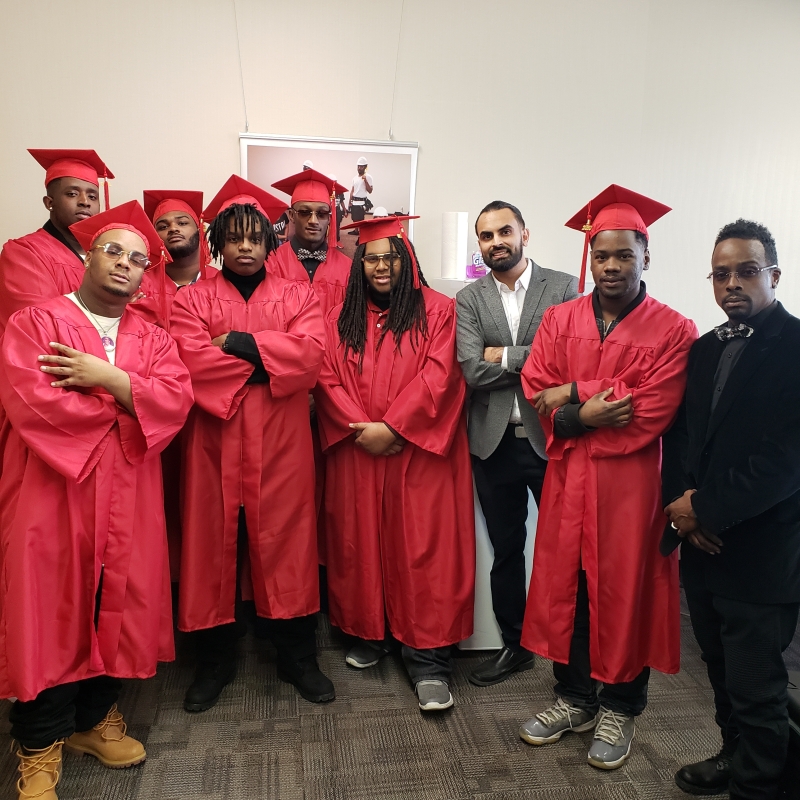 A group of people in red graduation gowns