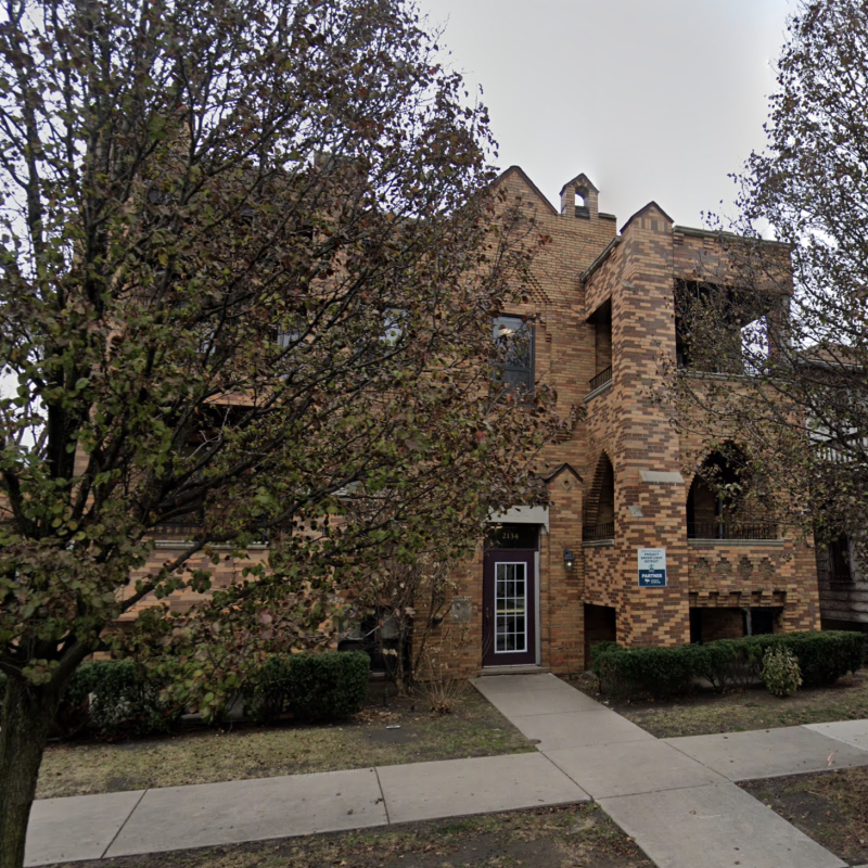 Apartment building partially covered by trees