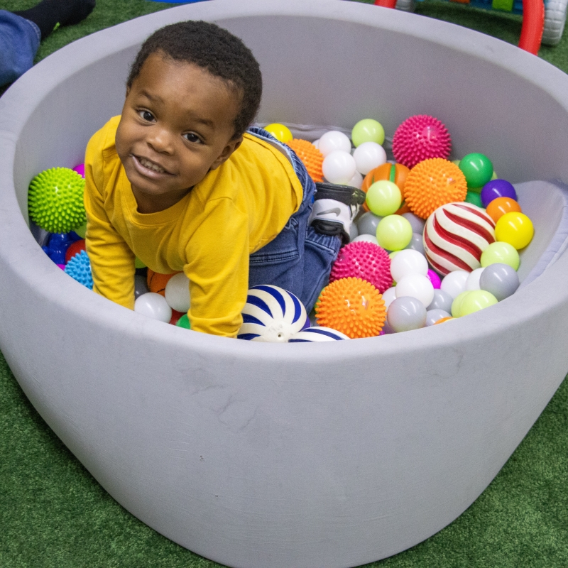 Child playing in ball pit