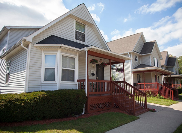 Front of a white siding house with a front porch